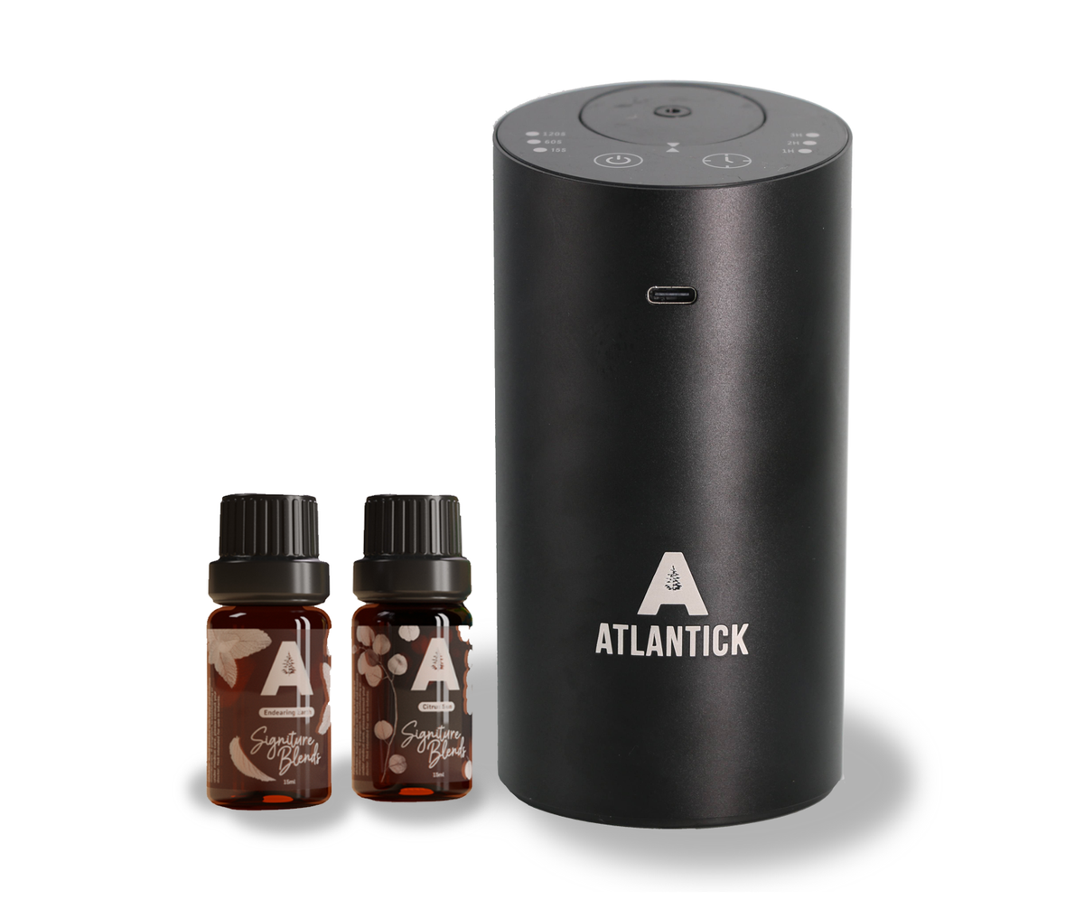 AtlanTick Portable Air Infuser – a sleek, black, waterless essential oil diffuser with two AtlanTick Signature Blend essential oils (Citrus Sun & Woodland Wanderer). Rechargeable, spill-proof, and perfect for home, car, or outdoor use.