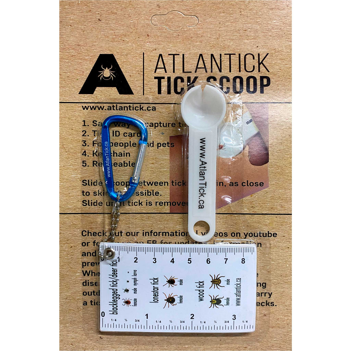 AtlanTick Tick Scoop Remover Keychain in packaging, featuring a white scoop tool with the AtlanTick logo, a blue carabiner, and a tick identification card with a ruler. The packaging provides instructions for safe tick removal and highlights its use for people and pets.